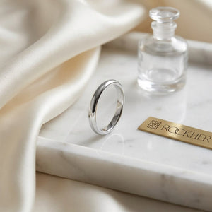 2mm Slightly Domed Comfort-Fit Wedding Band in 14K White Gold, on marble vanity tray with silk