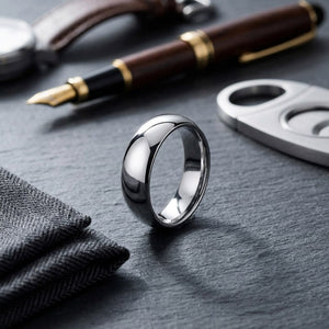 7mm Slightly Domed Comfort-Fit Wedding Band in 14K White Gold, on walnut surface with pocket square