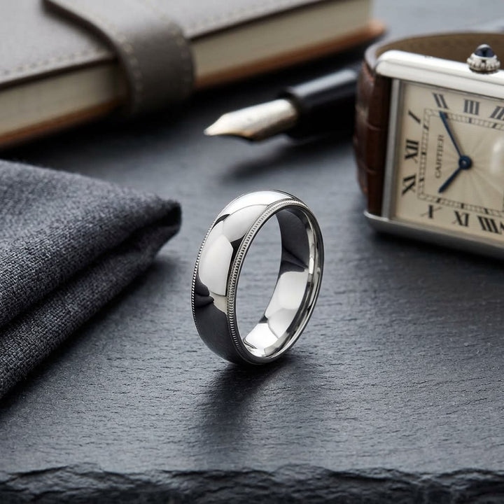 6mm Slightly Domed Milgrain Comfort-Fit Wedding Band in 14K White Gold, on walnut surface with pocket square