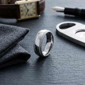 7mm Slightly Domed Double Milgrain Comfort-Fit Wedding Band in 14K White Gold, on walnut surface with pocket square