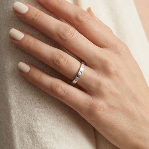 2mm High Polish Carved Wedding Band in 14K White Gold, worn on hand, close-up