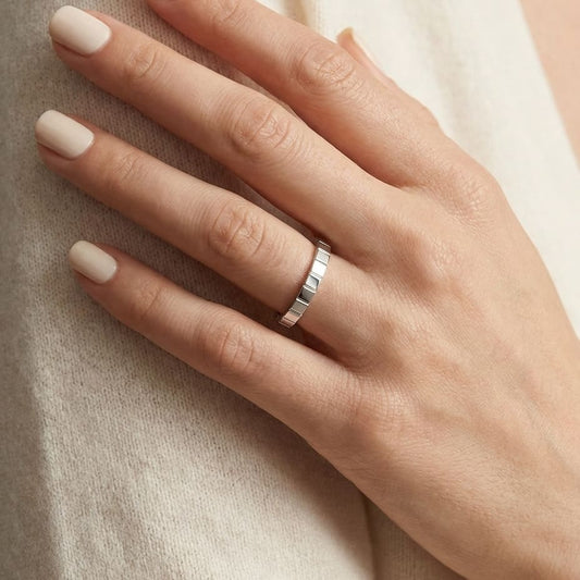 2mm High Polish Carved Wedding Band in 14K White Gold, worn on hand, close-up