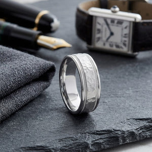 8mm Hammered Center High Polish Round Edge Carved Wedding Band in 14K White Gold, on walnut surface with pocket square