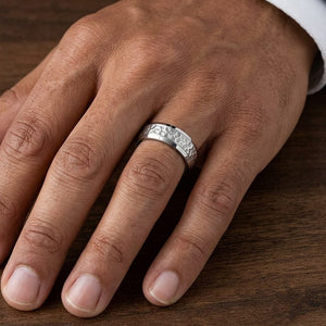 7.5mm Hammered Finish Beveled Edge Carved Wedding Band in 14K White Gold, worn on hand, masculine close-up