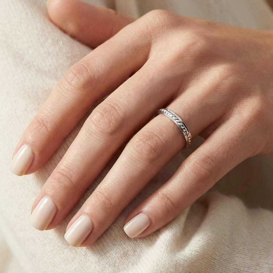 2mm High Polish Carved Wedding Band in 14K White Gold, worn on hand, close-up
