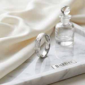 4mm Hammered Finish Carved Wedding Band in 14K White Gold, on marble vanity tray with silk