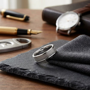 6mm High Polish Milgrain Round Edge Carved Wedding Band in 14K White Gold, on walnut surface with pocket square