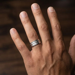 7.5mm High Polish Round Edge Carved Wedding Band in 14K White Gold, worn on hand, masculine close-up