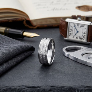 7.5mm High Polish Round Edge Carved Wedding Band in 14K White Gold, on walnut surface with pocket square