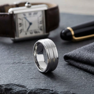 8mm Satin Finish High Polished Center Cut Carved Wedding Band in 14K White Gold, on walnut surface with pocket square