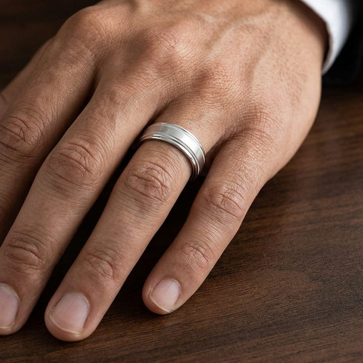 7mm Round Edge Swirl Finish Carved Wedding Band in 14K White Gold, worn on hand, masculine close-up