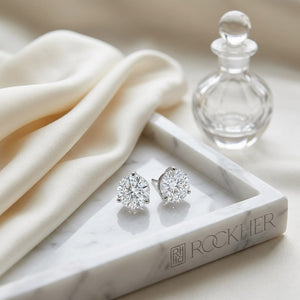 Martini Lab Diamond Stud Earrings | Round Brilliant, DEF VS Ideal Cut, IGI Certified, on marble vanity tray with silk