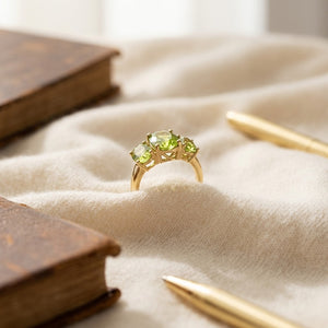 Peridot Oval Three Stone Ring in 14K Yellow Gold - flat lay