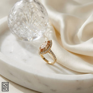 Morganite Marquise Halo Ring 14k Yellow Gold 0.24ctw, on marble vanity tray with silk