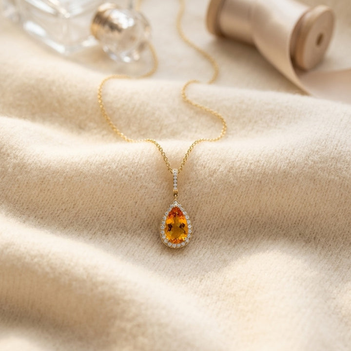 Citrine Pear & Diamond Halo Pendant in 14K Yellow Gold - flat lay
