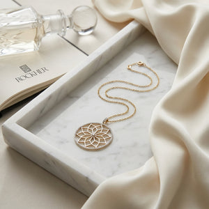 Diamond Snowflake Pendant With Circular Frame in 14k Yellow Gold 0.30ctw, 16-18 Inch Adjustable Rolo Chain, on marble vanity tray with silk