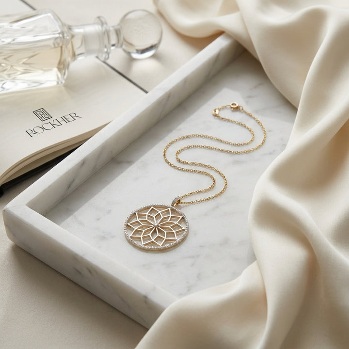 Diamond Snowflake Pendant With Circular Frame in 14k Yellow Gold 0.30ctw, 16-18 Inch Adjustable Rolo Chain, on marble vanity tray with silk