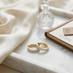 Diamond Princess Cut Channel Hinged Hoop Earrings in 14K Yellow Gold, on marble vanity tray with silk