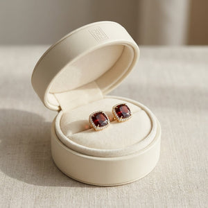 Garnet Cushion Stud Earrings in 14K Yellow Gold, in navy velvet jewelry box