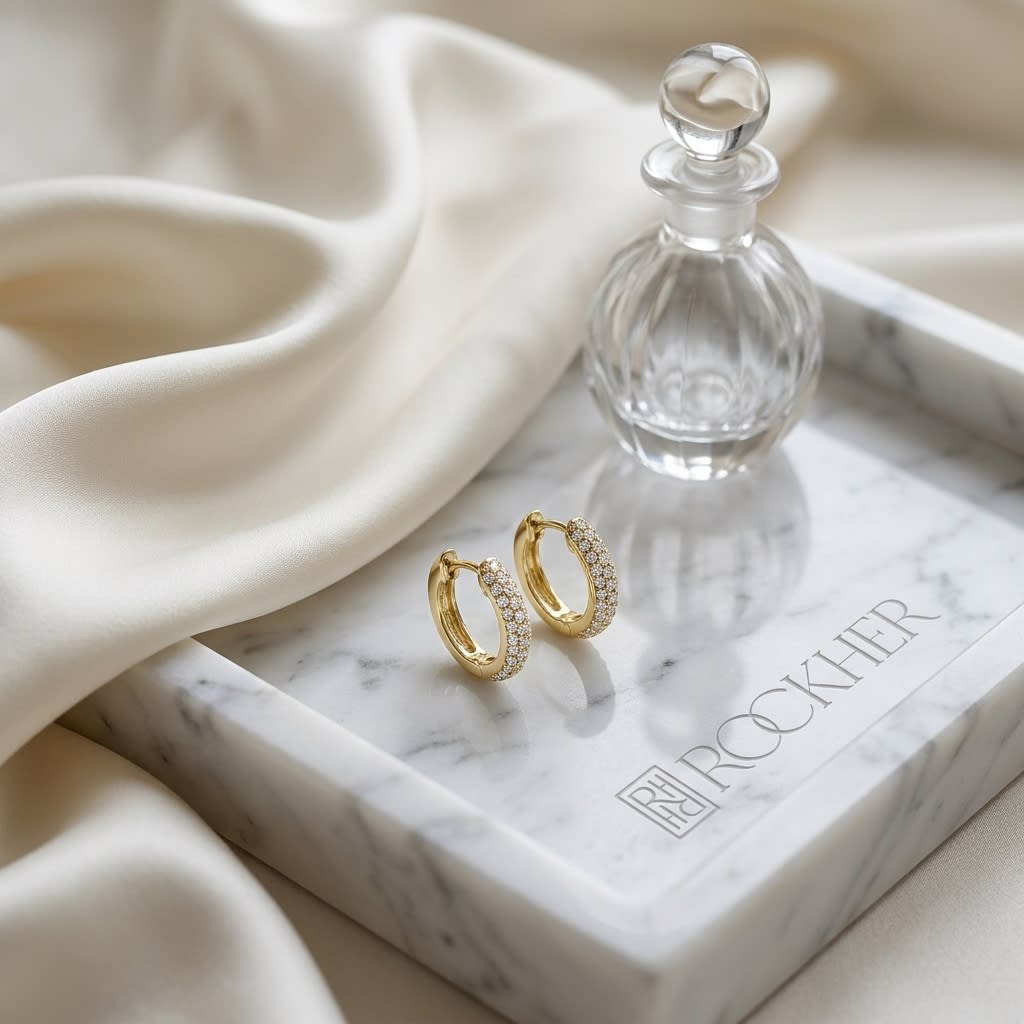 Micro Pave Diamond Huggie Earrings in 14K Yellow Gold 0.30ctw, on marble vanity tray with silk