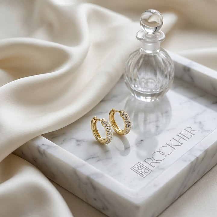 Micro Pave Diamond Huggie Earrings in 14K Yellow Gold 0.30ctw, on marble vanity tray with silk