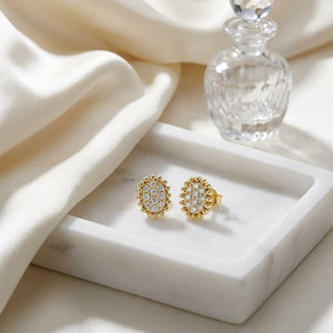 Natural Diamond Oval Stud Earrings in 14K Yellow Gold, on marble vanity tray with silk