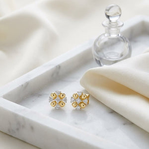 Natural Diamond Round Brilliant Stud Earrings in 14K Yellow Gold, on marble vanity tray with silk