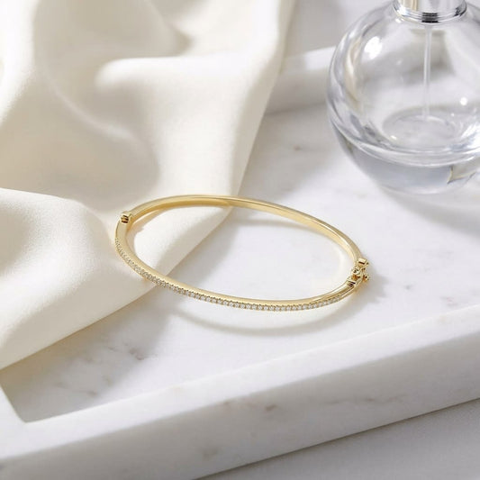 Pave Bangle in 14K Yellow Gold, on marble vanity tray with silk