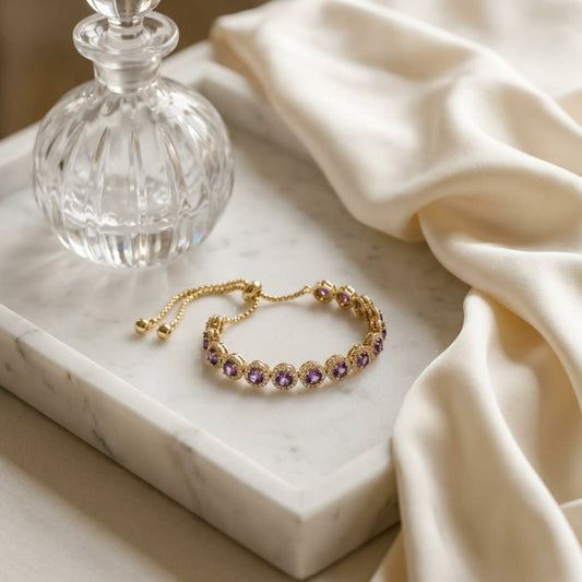 Alternating Amethyst and Diamond Bolo Bracelet in 14k Yellow Gold 1.0ctw, on marble vanity tray with silk