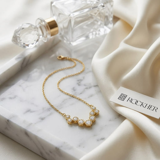 Diamond Prong Set Floating Circles Necklace in 14K Yellow Gold, on marble vanity tray with silk