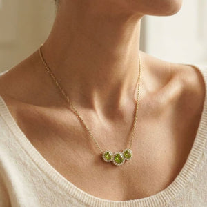 Round Peridot and Diamond Halo Necklace in 14K Yellow Gold, worn close-up portrait