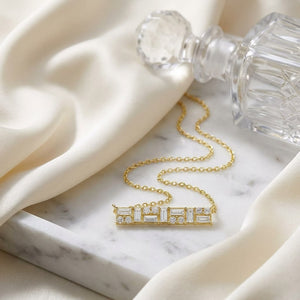 Diamond Baguette And Round Mosaic Bar Necklace in 14K Yellow Gold, 16-18 Inch Adj Chain, on marble vanity tray with silk