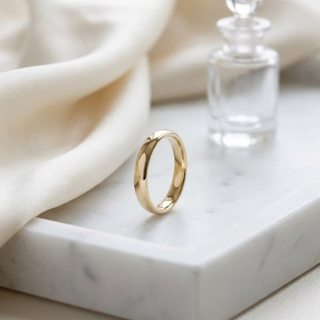 3.5mm Flat Comfort-Fit Wedding Band in 14K Yellow Gold, on marble vanity tray with silk