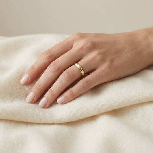 4mm High Dome Comfort-Fit Wedding Band in 14K Yellow Gold, worn on hand, full view