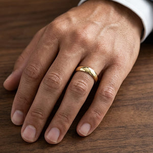 5mm High Dome Comfort-Fit Wedding Band in 14K Yellow Gold, worn on hand, masculine close-up