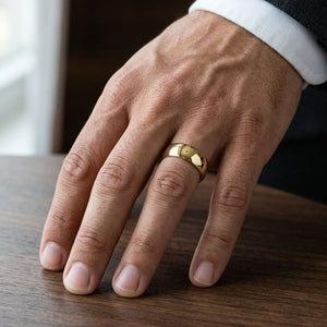 7mm Low Dome Wedding Band in 14K Yellow Gold, worn on hand, masculine close-up