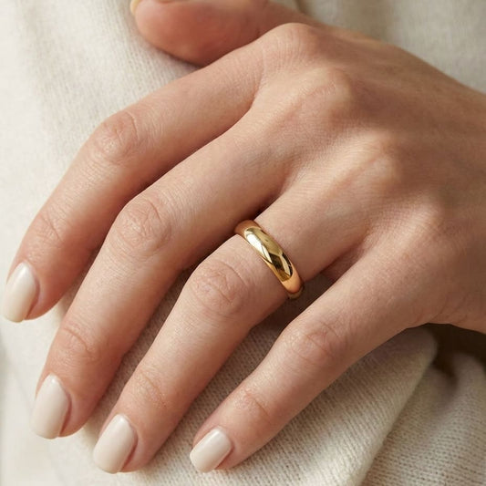 4mm Slightly Domed Comfort-Fit Wedding Band in 14K Yellow Gold, worn on hand, close-up