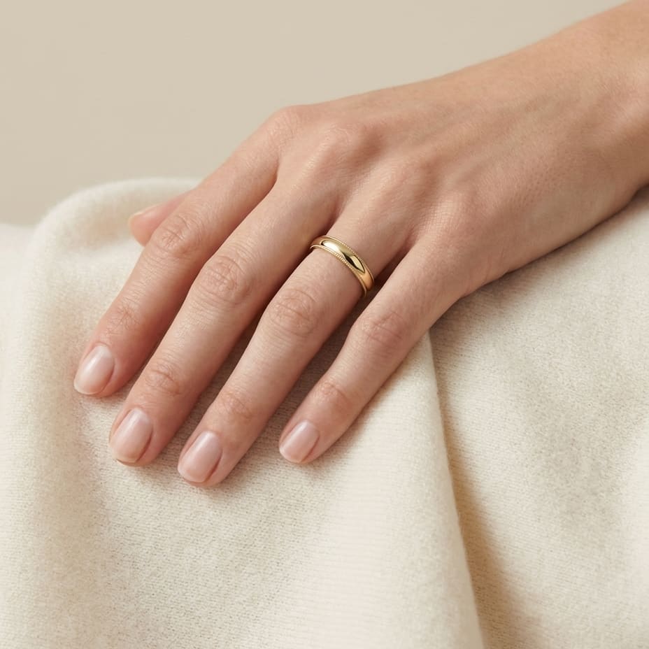 4mm Slightly Domed Milgrain Comfort-Fit Wedding Band in 14K Yellow Gold, worn on hand, full view
