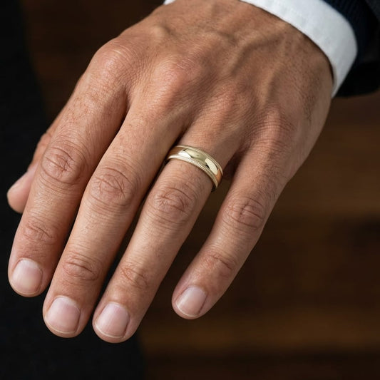 7mm Slightly Domed Double Milgrain Comfort-Fit Wedding Band in 14K Yellow Gold, worn on hand, masculine close-up