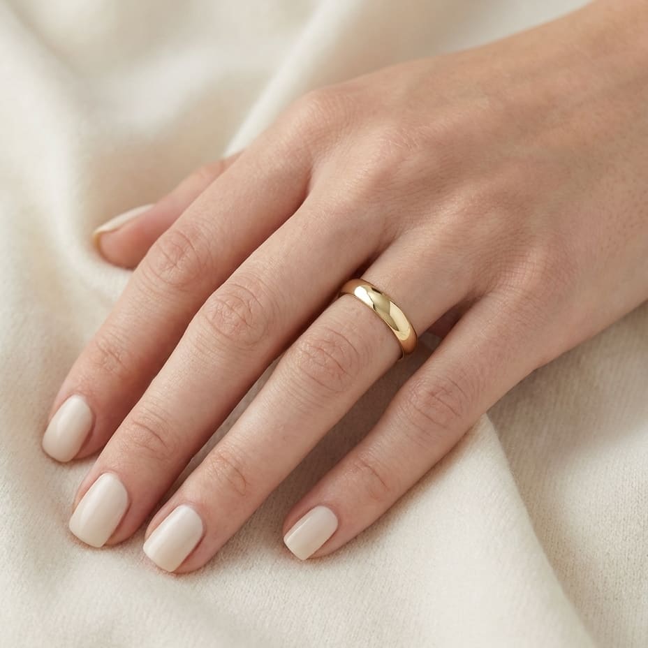 4mm Slightly Domed Super Light Comfort-Fit Wedding Band in 14K Yellow Gold, worn on hand, close-up