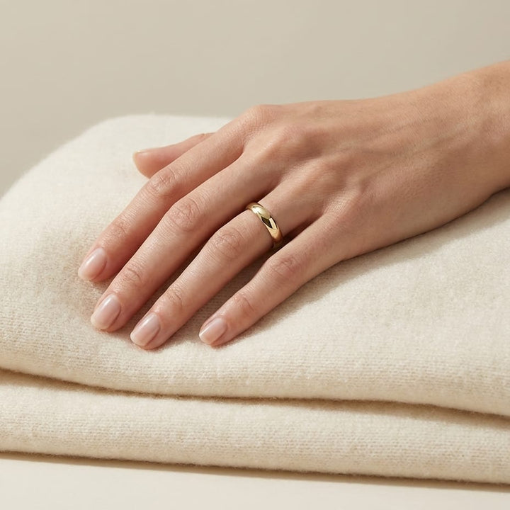 4mm Slightly Domed Super Light Comfort-Fit Wedding Band in 14K Yellow Gold, worn on hand, full view