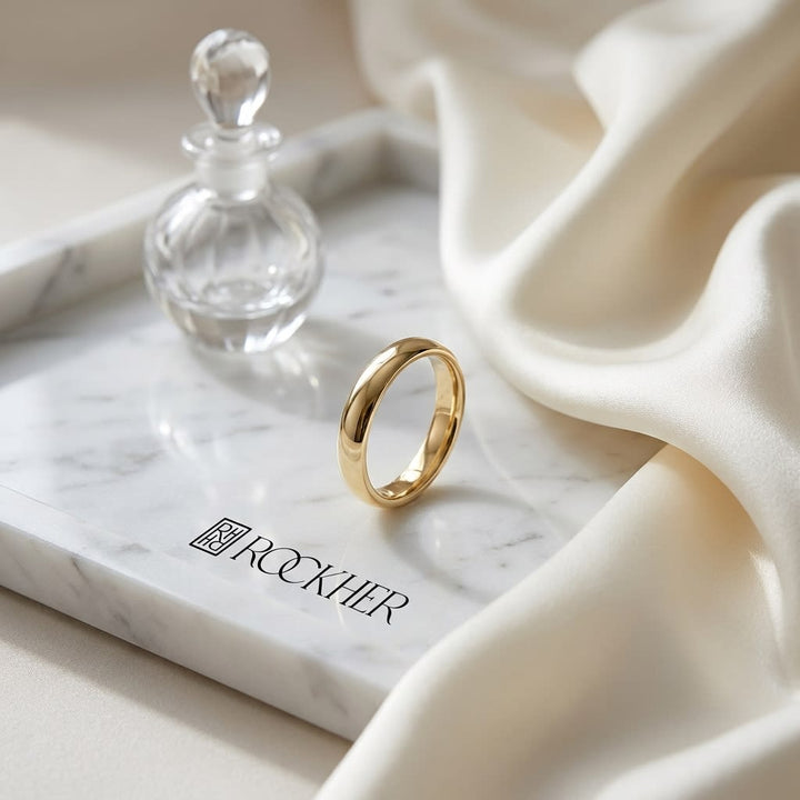 4mm Slightly Domed Super Light Comfort-Fit Wedding Band in 14K Yellow Gold, on marble vanity tray with silk