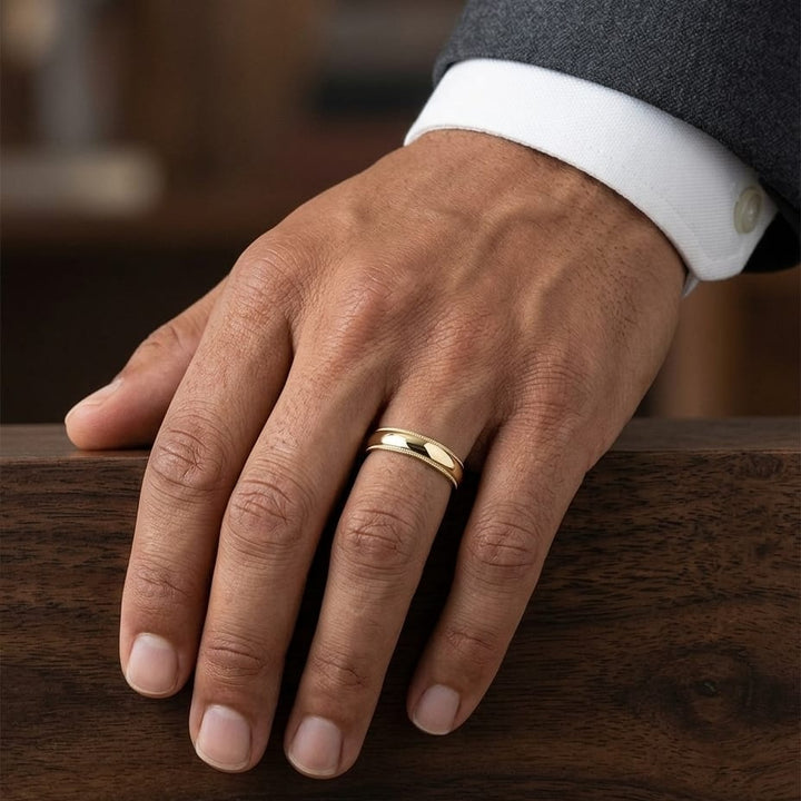 5mm Slightly Domed Super Light Milgrain Comfort-Fit Wedding Band in 14K Yellow Gold, worn on hand, masculine close-up