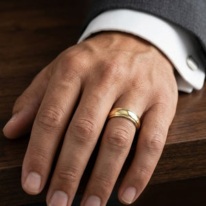6mm High Polish Carved Wedding Band in 14K Yellow Gold, worn on hand, masculine close-up