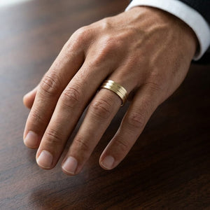 6mm Satin Finish Parallel Center Cut Carved Wedding Band in 14K Yellow Gold, worn on hand, masculine close-up