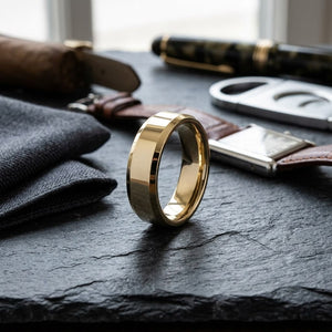 6mm High Polish Carved Wedding Band in 14K Yellow Gold, on walnut surface with pocket square