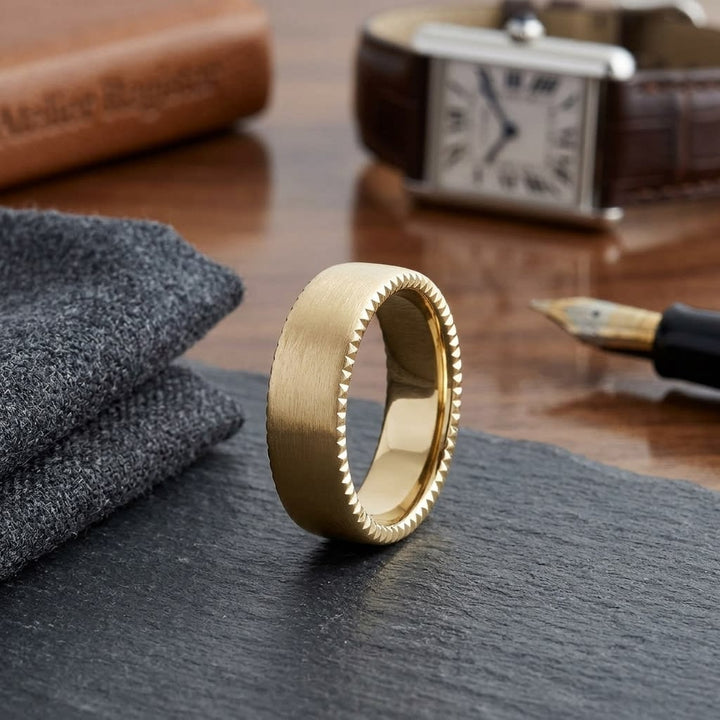 7.5mm Satin Finish Carved Wedding Band in 14K Yellow Gold, on walnut surface with pocket square