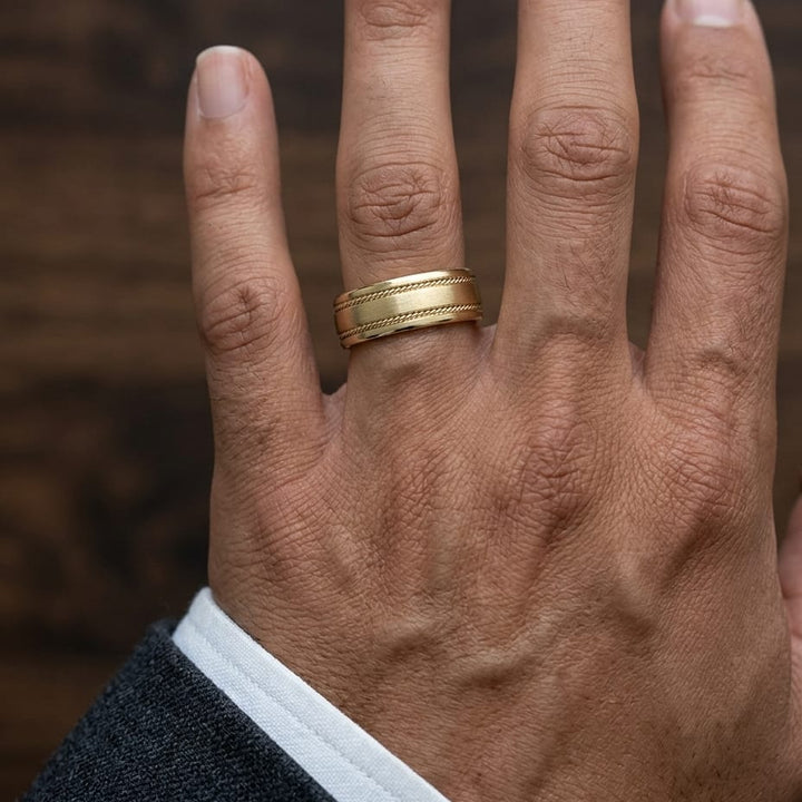 7.5mm Satin Finish Rope Carved Wedding Band in 14K Yellow Gold, worn on hand, masculine close-up