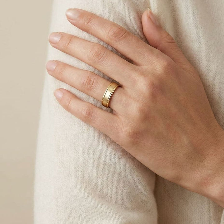4mm Satin Finish High Polished Round Edge Carved Wedding Band in 14K Yellow Gold, worn on hand, full view