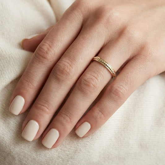2mm High Polish Carved Wedding Band in 14K Yellow Gold, worn on hand, close-up
